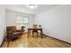 Bright home office with hardwood floors, desk, chair, and a cozy armchair by the window at 3298 S Krameria St, Denver, CO 80222
