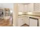 Stylish bar area featuring white cabinetry, a sink, and a built-in beverage cooler, ideal for entertaining at 15723 E Orchard Pl, Aurora, CO 80016