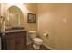 This bathroom features a marble sink, vanity, toilet, and decorative wall art at 15723 E Orchard Pl, Aurora, CO 80016