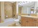 Cozy bathroom with a shower-tub combo, wooden vanity, and neutral tones, designed for daily comfort at 15723 E Orchard Pl, Aurora, CO 80016