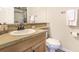 Well lit bathroom features a single sink vanity, tile countertop, and modern fixtures at 15723 E Orchard Pl, Aurora, CO 80016