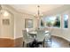 Bright dining room with chandelier, bay windows and hardwood floors at 15723 E Orchard Pl, Aurora, CO 80016