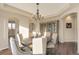 Dining area featuring chandelier, hardwood floors and a decorative hutch at 15723 E Orchard Pl, Aurora, CO 80016