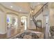 Grand foyer with staircase, hardwood floors, and archways leading to office and dining room at 15723 E Orchard Pl, Aurora, CO 80016