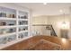 Second-floor landing featuring wood floors, a decorative rug, and built-in shelving at 15723 E Orchard Pl, Aurora, CO 80016