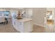 Open kitchen with stainless appliances and island overlooking Gathering room with fireplace and tv at 15723 E Orchard Pl, Aurora, CO 80016