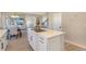 Large kitchen island with quartz countertop and seating, overlooking living room and fireplace at 15723 E Orchard Pl, Aurora, CO 80016