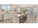 Spacious kitchen with white cabinetry, an island with seating, and stainless steel appliances at 15723 E Orchard Pl, Aurora, CO 80016