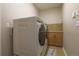 Bright laundry room includes modern washer and dryer, tile floor, and storage space at 15723 E Orchard Pl, Aurora, CO 80016