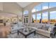 Spacious living room with large windows, open-concept design, and stylish decor at 15723 E Orchard Pl, Aurora, CO 80016