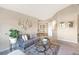 Cozy living room featuring a modern sofa, glass coffee table, and stylish decor at 15723 E Orchard Pl, Aurora, CO 80016