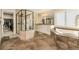 Elegant bathroom with a glass shower, soaking tub, and double vanity, designed for relaxation and convenience at 15723 E Orchard Pl, Aurora, CO 80016