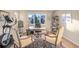 Bright home office featuring a large window, hardwood floors, and comfortable seating at 15723 E Orchard Pl, Aurora, CO 80016