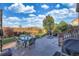 Outdoor patio with ample seating and outdoor cooking area overlooking lush green backyard with mature trees at 15723 E Orchard Pl, Aurora, CO 80016