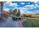 Outdoor patio with ample seating, manicured lawn and mature trees at 15723 E Orchard Pl, Aurora, CO 80016