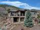 Beautiful backyard featuring a stone patio, landscaping, and a private outdoor living space at 5951 Rain Dance Trl, Littleton, CO 80125