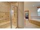 Beautifully remodeled primary bathroom featuring a glass enclosed shower and a soaking tub at 5951 Rain Dance Trl, Littleton, CO 80125