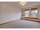 Good sized bedroom with neutral walls and carpet and views to the outside at 5951 Rain Dance Trl, Littleton, CO 80125