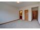 View of the bedroom into the adjoining bathroom with double sinks and wood cabinets at 5951 Rain Dance Trl, Littleton, CO 80125