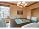 Dining room with a large table, modern lighting, and mountain views at 5951 Rain Dance Trl, Littleton, CO 80125