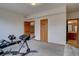 View of the exercise room with workout equipment and access to an adjoining bathroom at 5951 Rain Dance Trl, Littleton, CO 80125