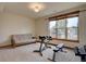Bright and airy exercise room with large windows and workout equipment at 5951 Rain Dance Trl, Littleton, CO 80125