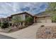 Charming home with a three-car garage, landscaped front yard, and stucco and stone accents at 5951 Rain Dance Trl, Littleton, CO 80125