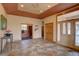Elegant foyer with tile floors, decorative ceiling, and a view of the front entrance at 5951 Rain Dance Trl, Littleton, CO 80125