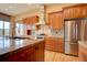 Modern kitchen with stainless steel appliances, granite countertops, and wood cabinetry at 5951 Rain Dance Trl, Littleton, CO 80125