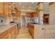 Gourmet kitchen with stainless steel appliances, granite countertops, and wood cabinetry at 5951 Rain Dance Trl, Littleton, CO 80125