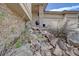 Landscaping features a decorative rock waterfall with a stone column entranceway and pottery at 5951 Rain Dance Trl, Littleton, CO 80125