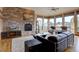 Bright living room featuring a stone fireplace, hardwood floors, and mountain views at 5951 Rain Dance Trl, Littleton, CO 80125