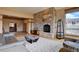 Spacious living room boasts a stone fireplace, wood floors, and neutral color palette at 5951 Rain Dance Trl, Littleton, CO 80125