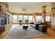 Spacious living room boasts large windows, fireplace, and hardwood floors at 5951 Rain Dance Trl, Littleton, CO 80125