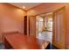 Home office space with built-in bookshelves and easy access to the entryway at 5951 Rain Dance Trl, Littleton, CO 80125