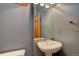 Cozy powder room with pedestal sink and decorative mirror at 5951 Rain Dance Trl, Littleton, CO 80125