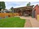 Inviting backyard features a wooden pergola, a sauna, and lush green lawn for relaxation and entertainment at 3237 N Josephine St, Denver, CO 80205