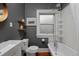 Modern bathroom featuring a sink, toilet, tub, and white tiled wall at 3237 N Josephine St, Denver, CO 80205