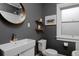 Modern bathroom featuring a sink, toilet, and floating shelves at 3237 N Josephine St, Denver, CO 80205