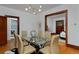 Stylish dining room with a glass table, modern chandelier, and hardwood floors at 3237 N Josephine St, Denver, CO 80205