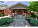 Charming brick home with a cozy front porch and manicured landscaping at 3237 N Josephine St, Denver, CO 80205