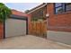 Spacious two-car garage with a wooden gate offering both functionality and privacy at 3237 N Josephine St, Denver, CO 80205