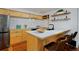 Modern kitchen features a breakfast bar, stainless steel appliances, and modern cabinets at 3237 N Josephine St, Denver, CO 80205