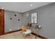 Home office featuring a glass desk, tile floor, and modern giraffe wall art at 3237 N Josephine St, Denver, CO 80205