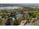 Community with a pool, tennis courts, green spaces, and a lake in the background at 7761 S Curtice Dr # C, Littleton, CO 80120