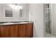 Bright bathroom features granite countertops with double sinks and a glass-enclosed shower at 7761 S Curtice Dr # C, Littleton, CO 80120