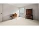 Bedroom featuring an antique desk, armoire, and large window at 7761 S Curtice Dr # C, Littleton, CO 80120