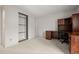 Bedroom with closet, and large wooden built-in desk and storage, and neutral carpet at 7761 S Curtice Dr # C, Littleton, CO 80120