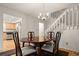 Cozy dining area with hardwood floors, chandelier, and access to the staircase and kitchen at 7761 S Curtice Dr # C, Littleton, CO 80120