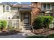 Charming townhouse with a brick chimney, covered entry and landscaped garden area at 7761 S Curtice Dr # C, Littleton, CO 80120